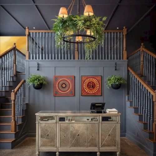 A festive indoor scene with stacked crates, a wooden pallet, and banners, set on a stage-like platform with a brick backdrop and dim lighting.